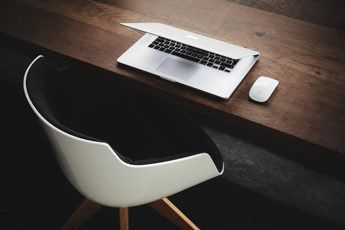 Laptop on a desk with financial documents — automating freelance admin work with AI