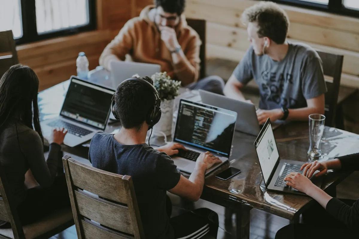 A team collaborating around a table — how to onboard a new client with a checklist and email templates